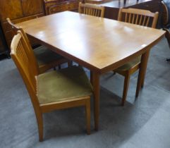 A teak rectangular extending dining table and four chairs