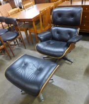 A Charles & Ray Eames style simulated rosewood and black leather revolving lounge chair and ottoman