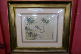 A Chinese watercolour on silk, bird amongst bamboo and blossom, 36 x 47cms, framed