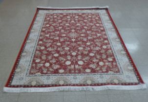 An Iranian red ground rug, 308cm x 201cm