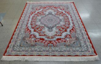 An Iranian red ground rug, 242cm x 162cm