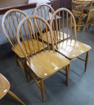 A set of four Ercol Blonde elm and beech Windsor chairs