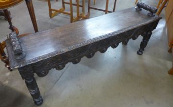 A Victorian Jacobean Revival carved oak window seat