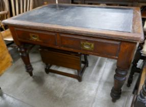 A Victorian pitch pine two drawer writing table
