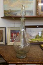 A tall glass chemist's bottle