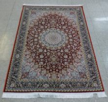 An Iranian red ground rug, 190cm x 121cm