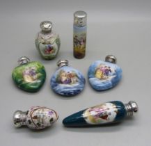 A collection of seven hand painted continental scent bottles with hallmarked silver lids, all lids