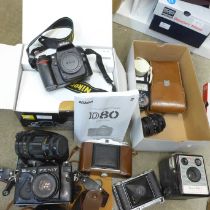 A collection of cameras including a Zenit 12XP, Agfa, Voightlander, Kodak, a wide angle lens, one