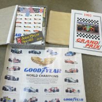 A collection of Formula 1 memorabilia including stickers, race programmes, tickets, calendars,