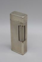 A vintage silver plated Dunhill lighter with engine turned detail