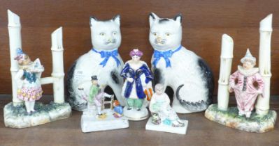 A pair of Victorian Staffordshire cats, a pair of Victorian figural male and female Pierrot specimen