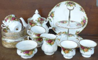 A six setting Royal Albert tea set with sugar bowl, milk jug, two tier sandwich plate, teapot and