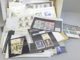 Stamps; a box of world stamps on packets and stock cards