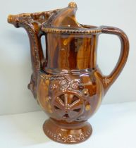 A treacle glaze pottery puzzle jug, 26cm