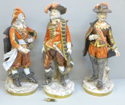 A set of three German Unter Weiss Bach figures of the Three Musketeers, one sword on one figure a/f