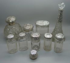 Ten silver topped glass bottles including a globular glass scent bottle, lid a/f