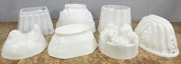 Seven large ceramic jelly moulds including hen, rabbits, fish, rose and lion, two marked Green's and