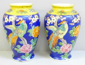 A pair of Japanese blue and yellow vases decorated with birds and flowers, chip to one base, 15cm