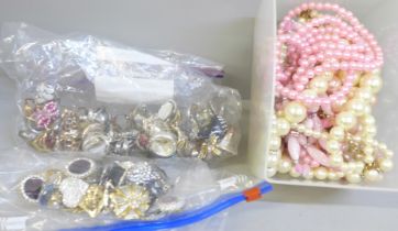 A box of faux pearls, twelve paris of earrings and forty-seven costume rings