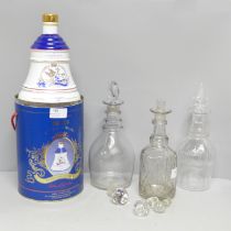 Three glass decanters including a Georgian example, three decanter stoppers and a Bell's Scotch