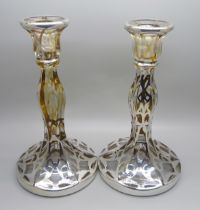 A pair of silver covered glass candlesticks, 19cm,(lacking some silver detail)