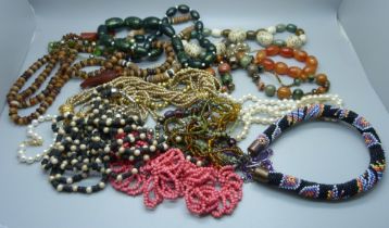 A bag of bead jewellery and an orange stone bracelet