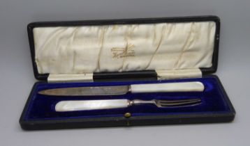 A silver and mother of pearl handled knife and fork christening set, Sheffield 1912, Isaac Ellis &