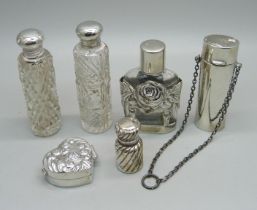 A silver pill box and five silver and silver mounted scent bottles