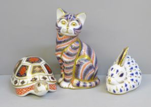 Three Royal Crown Derby paperweights; rabbit and cat with gold stoppers, tortoise lacking stopper