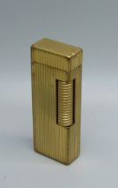 A gold plated Dunhill lighter