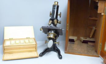 A Watson microscope, cased and a case containing slides, microscope marked Service W. Watson &