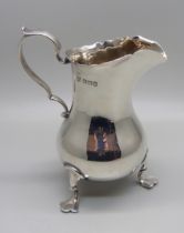 A silver jug with three pad feet, Sheffield 1906, 88g