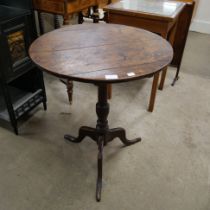 A George III circular oak tilt top tripod table