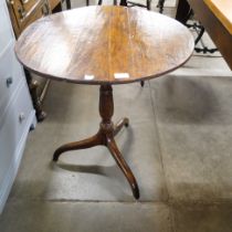 A George III circular oak tilt-top tripod table