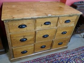 A Victorian pitch pine chest of nine drawers