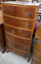 An oak bow front chest of drawers