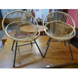 A pair of bamboo and black tubular steel ball chairs