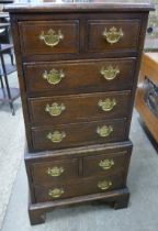 A small George III style oak chest on chest