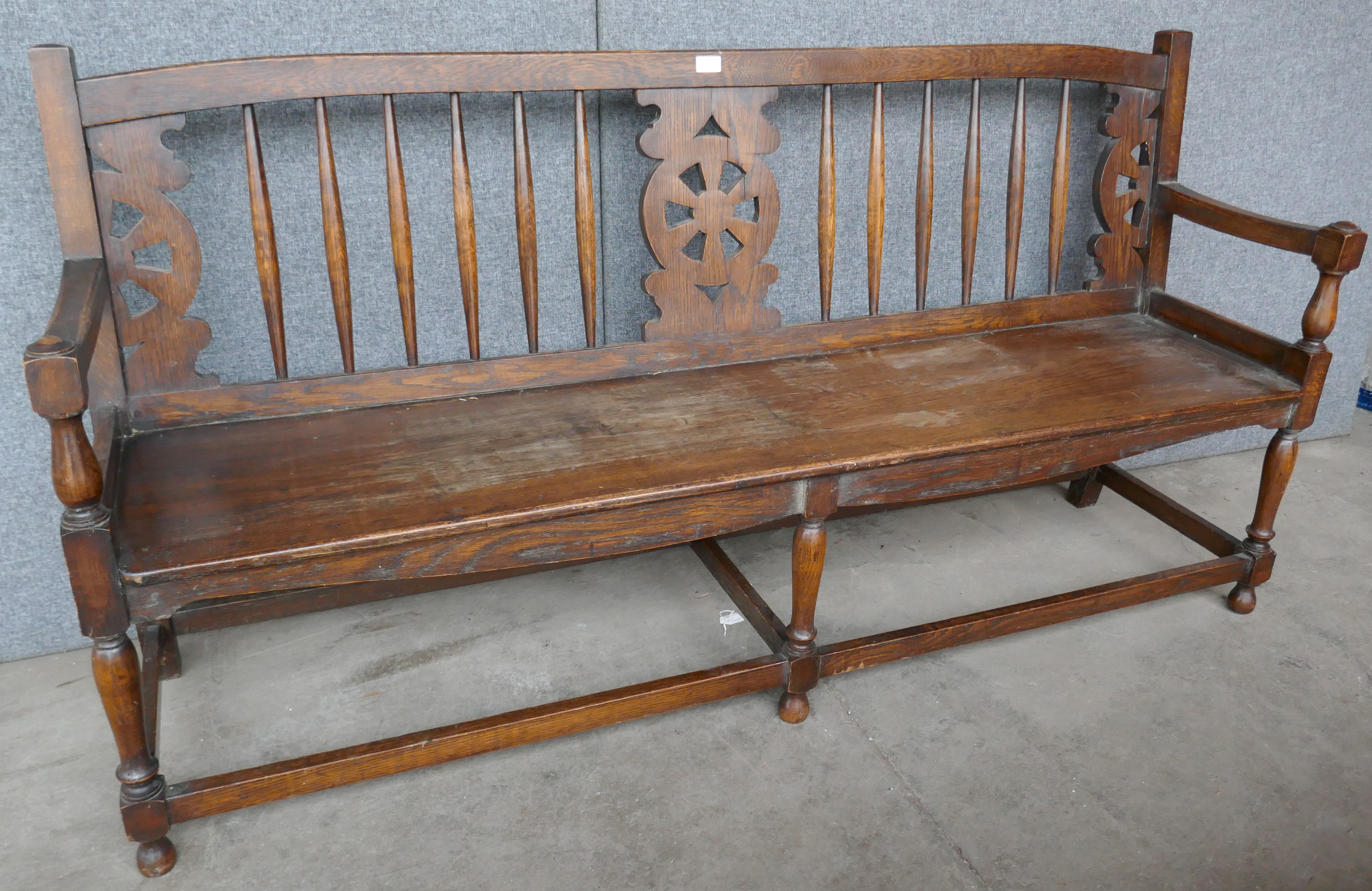 An early 20th Century oak and elm bench