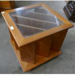 A teak and glass topped coffee table/magazine rack
