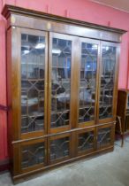 A George III style inlaid mahogany astragal glazed eight door library bookcase