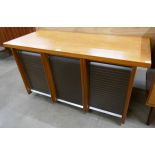 A teak tambour front office cabinet