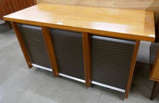 A teak tambour front office cabinet