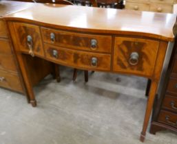 A Regency style inlaid mahogany serpentine sideboard