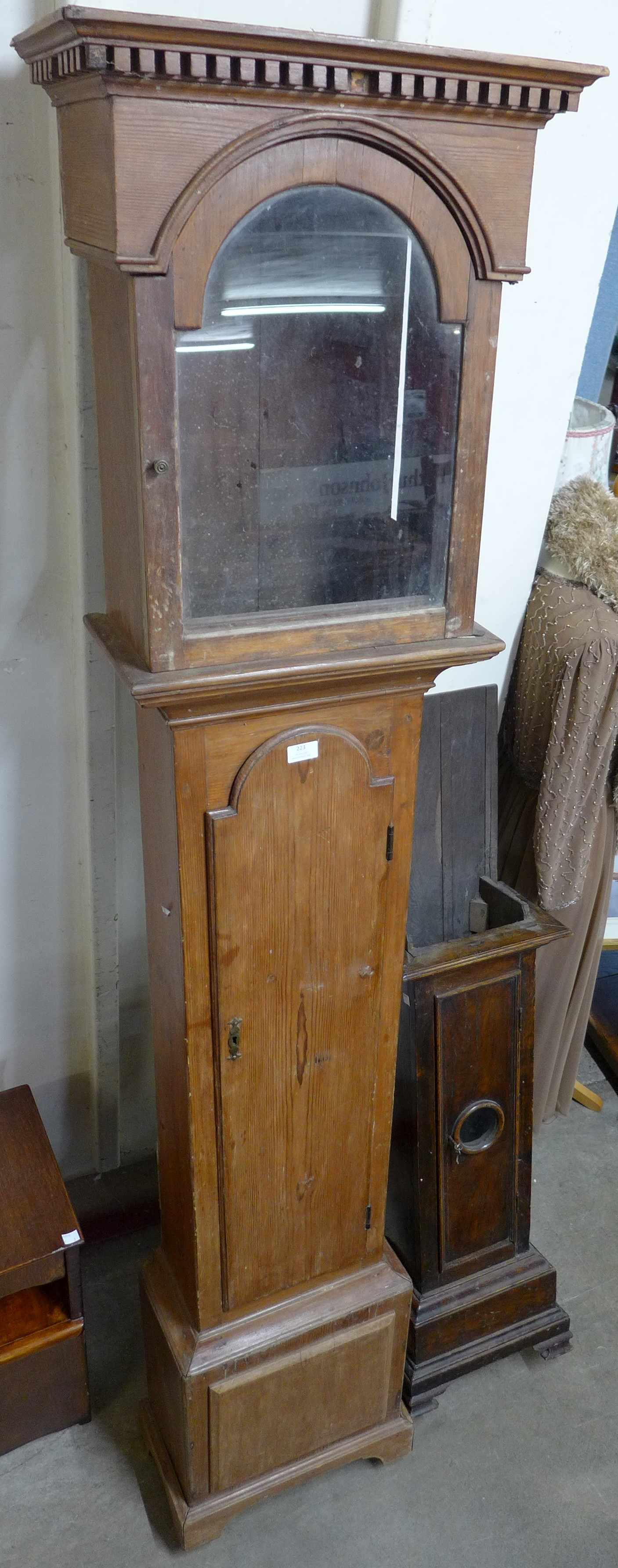 An early 18th Century pine longcase clock case and a 17th Century oak dwarf cased clock case