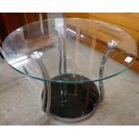 A circular glass and chrome coffee table