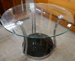 A circular glass and chrome coffee table