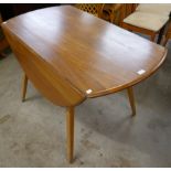 An Ercol elm.and beech Windsor drop-leaf dining table