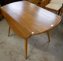 An Ercol elm.and beech Windsor drop-leaf dining table