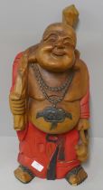 A painted carved wooden figure of a buddha